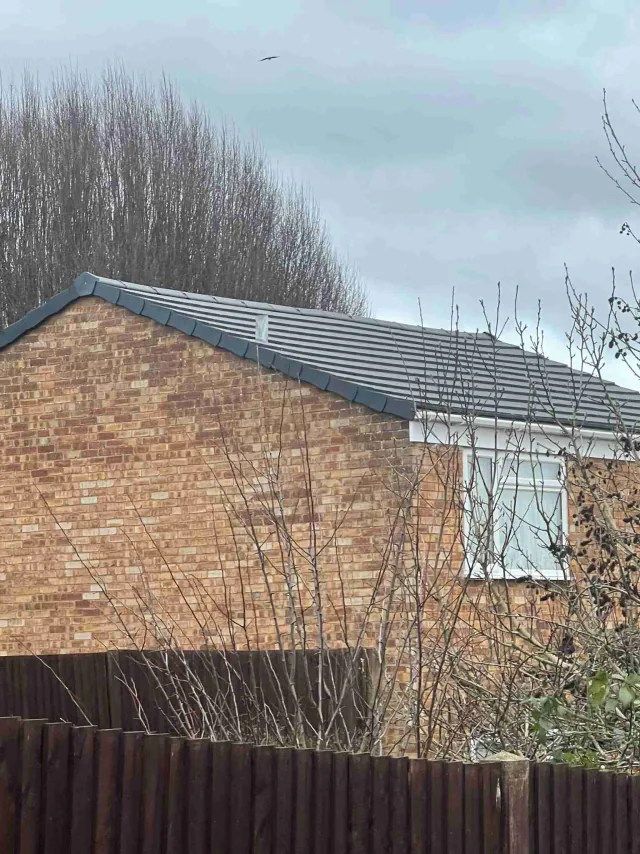 Brick gable below a grey roof