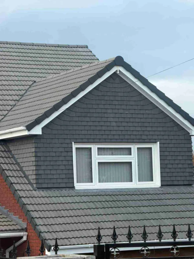 Clad dormer above a tiled roof