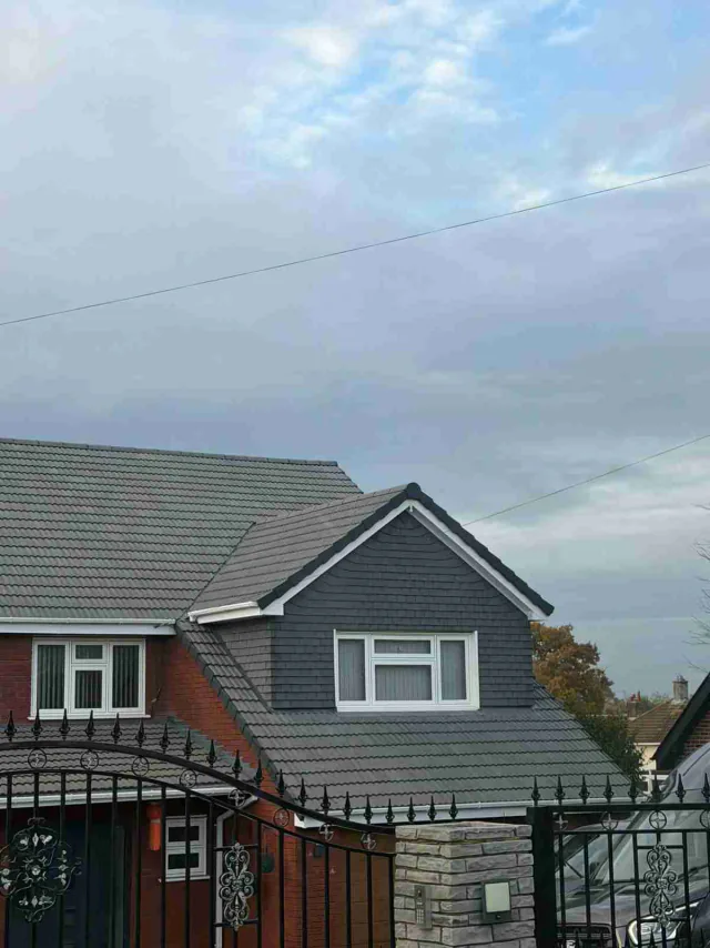 Clad gable and adjoining grey roof
