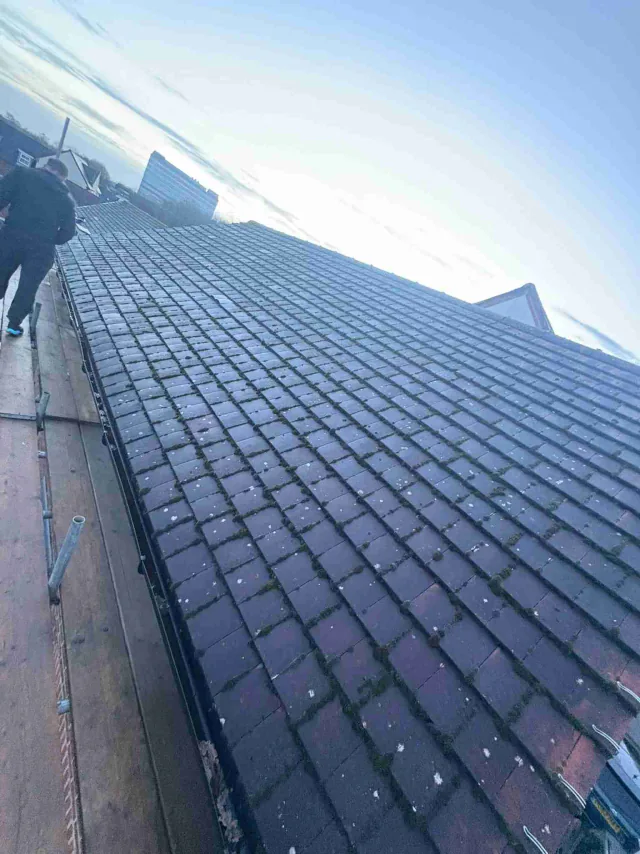 Dark roof tiles viewed from the scaffold