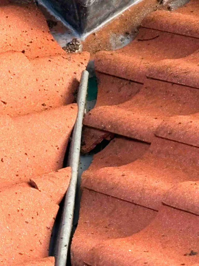 Flashing between roof tiles