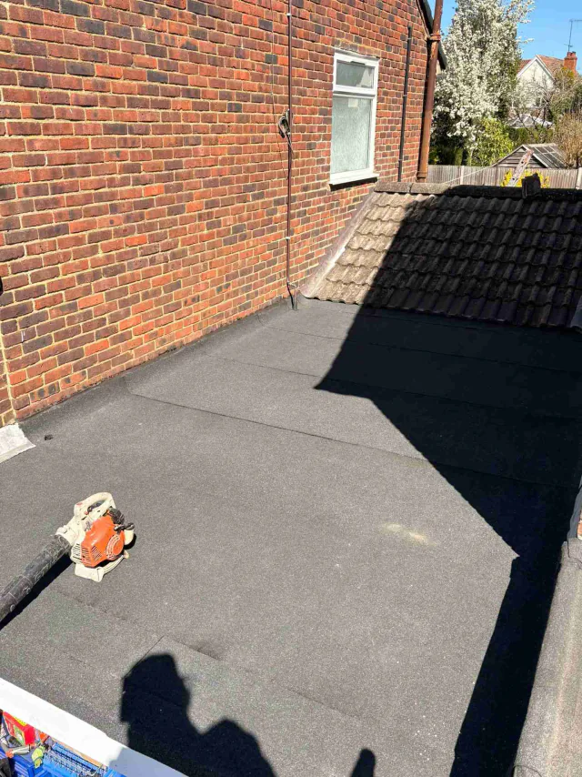 Flat roof adjoining a brick extension