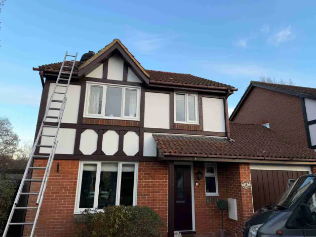 Front of a house with ladder access to the roofline