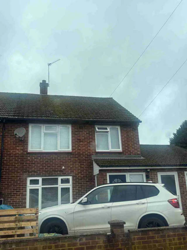 Front view of a brick house and pitched roof