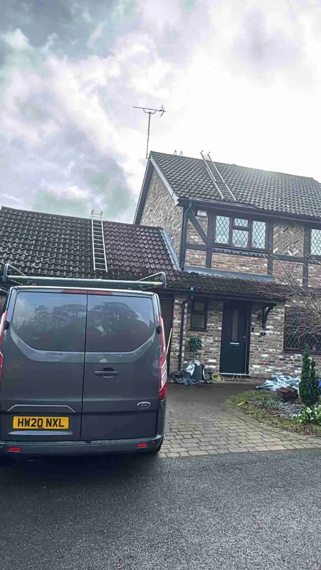 House frontage with pitched roofs and work vehicle
