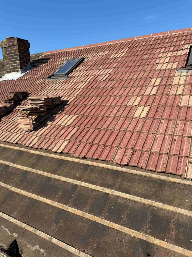 Partial stripping of a red tiled roof