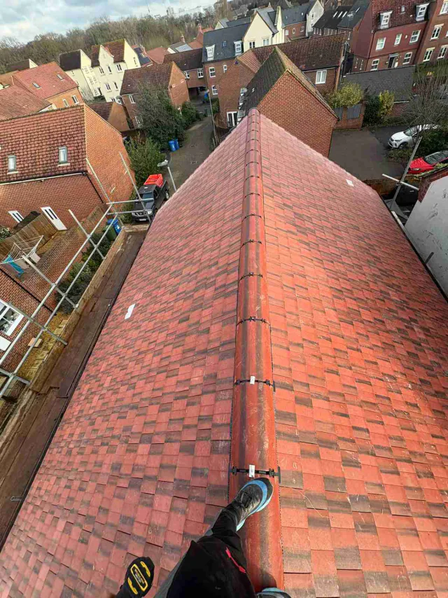 Red roof tiles and a long ridge line