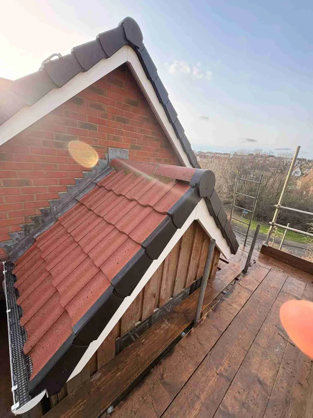 Red tiled roof below a gable