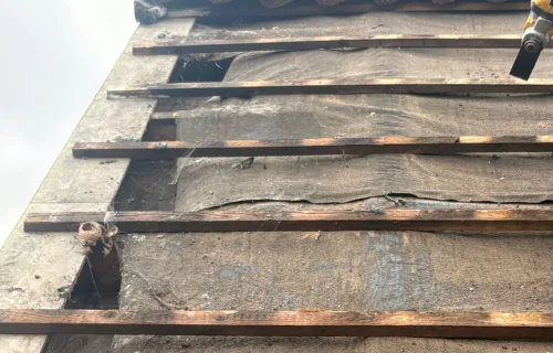 Emergency roof repair in progress by WWR Roofing on a damaged residential roof