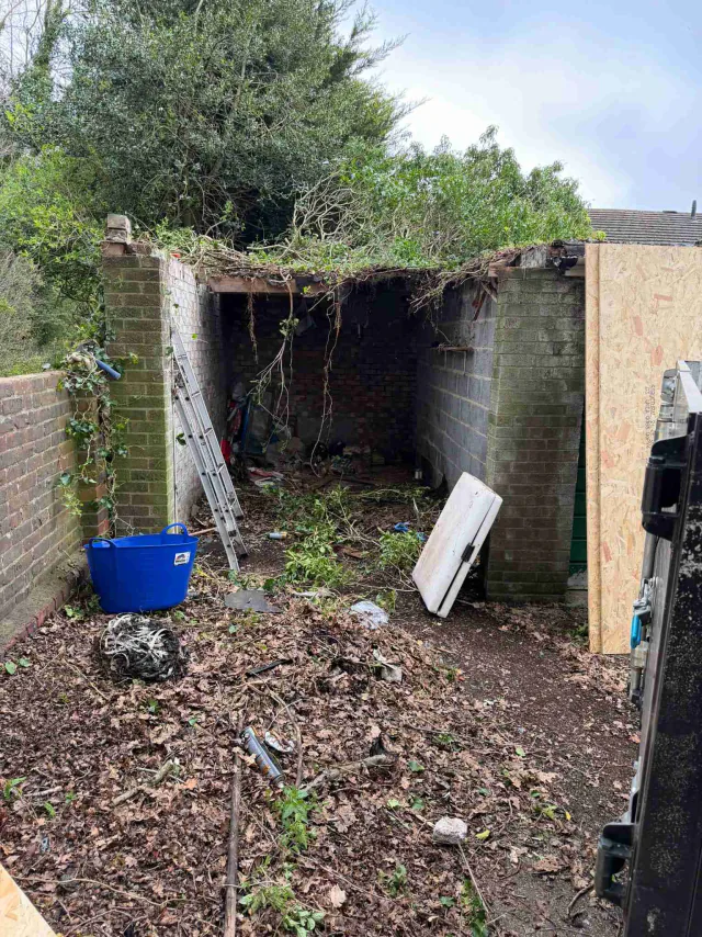 Roof work beside a garden wall