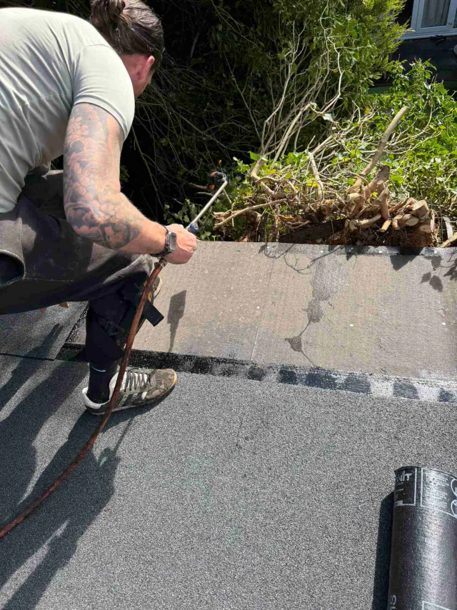 Roofing felt along a flat roof edge