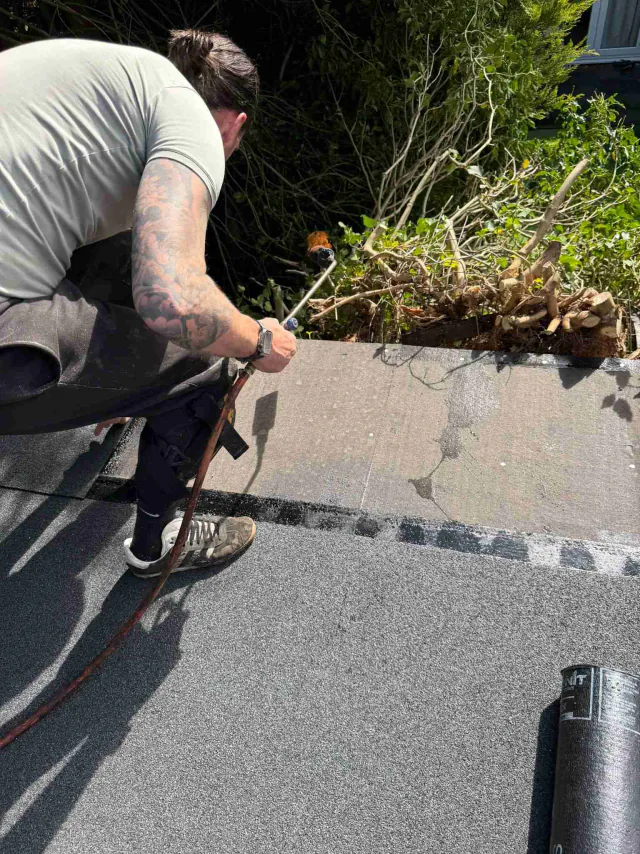Roofing felt along a flat roof edge