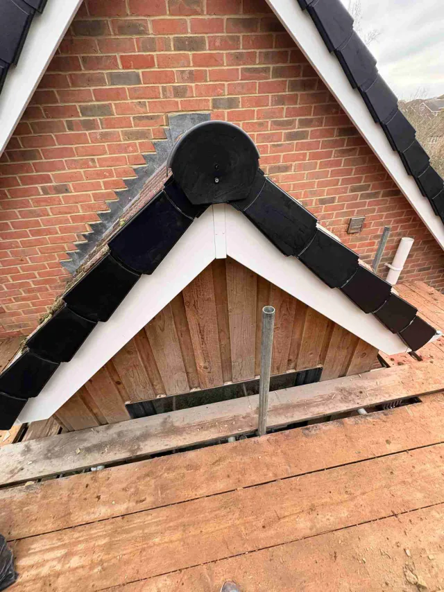 White fascia detail at a small tiled gable