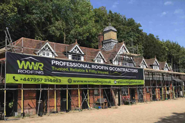 WWR Roofing scaffold banner on a large property