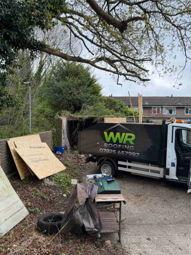 WWR Roofing vehicle beside roof work